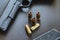 .45 Caliber hollow point bullets near handgun and magazine on le