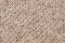 45 degree rotated pattern of a decorative beige sackcloth or burlap cloth. Close up view