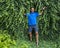 47 year-old Caucasian male posing in front of a dense wall of green ivy in Bar Harbor, Maine.