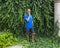 47 year-old Caucasian male posing in front of a dense wall of green ivy in Bar Harbor, Maine.