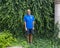 47 year-old Caucasian male standing in front of a dense wall of green ivy in Bar Harbor, Maine.