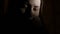 4Closeup portrait of a depressed teen girl in the dark. 4K UHD.