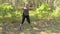 4k 50fps Young woman does athletic exercises in a wood.