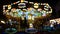 4K. abstract blur children`s merry-go-round carousel at night with bokeh light on festival for background