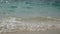 4K. abstract blur of soft wave of the sea with sound, clear water on the white sand beach with copy space area.