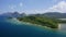 4K Aerial drone high attitude view flying towards a deserted tropical beach on mainland with towering limestone karst