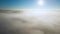 4K Aerial Drone Rise through Fog, emerges to sunrise