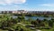 4K. Aerial drone shot. Lake view in a city park sunny day.