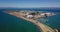 4k aerial drone view of treasure island san francisco bay area surrounded by turquoise blue ocean sea water waves camera hold