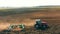 4K Aerial Elevated View.Tractor Plowing Field. Beginning Of Agricultural Spring Season. Cultivator Pulled By A Tractor