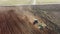 4K Aerial Elevated View.Tractor Plowing Field. Beginning Of Agricultural Spring Season. Cultivator Pulled By A Tractor