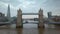 4K aerial footage of the famous Tower Bridge with iconic red double-decker buses