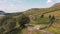 4K Aerial footage panning around a church revealing the beautiful Peak District