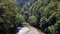 4K aerial point of view. Low altitude flight over fresh fast mountain river with rocks at sunny summer morning. Green