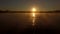 4k Aerial - Professional swimmer trains butterfly style at sunset.