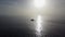 4K Aerial shot yacht sails in the ocean at sunrise