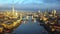 4K aerial skyline view of East London at sunrise with Tower Bridge and skyscrapers