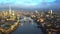 4K aerial skyline view of East London at sunrise with Tower Bridge and skyscrapers