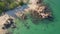 4K aerial slowmotion shot of a beautiful rocks at a tropical beach