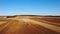 4K. Aerial view of agriculture process: tractors are plows and makes seeding, sowing agricultural crops at field