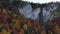4K aerial view of autumn, waterfall, flying over forest in the autumn, big stones in the river, waterfall with big
