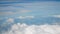 4K aerial view. flight over puffy fluffy white clouds blue sky. cloudscape background