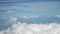 4K aerial view. flight over puffy fluffy white clouds blue sky. cloudscape background