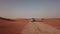 4K Aerial view following new e-tron in the desert of Abu dhabi. U.A.E. Electric car in desert