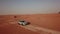 4K Aerial view following new e-tron in the desert of Abu dhabi. U.A.E. Electric car in desert