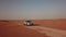 4K Aerial view following new e-tron in the desert of Abu dhabi. U.A.E. Electric car in desert