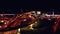 4K. Aerial view of highway road interchange with busy urban traffic speeding on the road at night. Junction network of