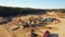 4K. Aerial view of a large Sand Quarry in working process with heavy machinery: sorting conveyor, bulldozers, excavators, trucks