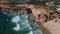 4K aerial view ocean waves rocky, cliffs sandy coast, beach Portugal 25 april 2023