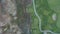 4k Aerial View Over a Golf Course and the Group of Brown Trees Next to it