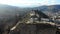 4k aerial view of the top of Narikala fortress, cross and tourists on peak