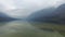 4K. Amazing Bohinj Lake in foggy weather and bird on the stone, panoramic view. Julian Alps, Triglav National Park, Slovenia.