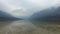 4K. Amazing Bohinj Lake in foggy weather, stones and the bird, panoramic view. Julian Alps, Triglav National Park, Slovenia.