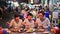 4K Asian family enjoy eating food on street food restaurant with crowd of people at Yaowarat road
