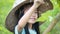 4K Asian little girl wearing farmer hat in green nature farm with happiness