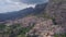 4k backwards aerial footage of historic Italian town in the mountains at sunset