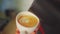 4k, barista pouring milk into espresso coffee for making cappuccino, latte art, slow motion