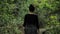 4k beautiful girl in black handmade skirt squares textures, defile on a wooden way deep in the green forest in