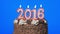 4k - Blowing out new year 2016 candles on a delicious chocolate cake, blue screen