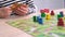 4k Board game and kids leisure concept - child hands close up playing wood chips people figure in children table top