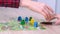 4k Board game and kids leisure concept - kids hands close up playing wood chips people figure in children table top game