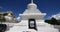 4k busy traffic & pedestrian through white stupa in Lhasa,Tibet.