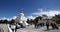 4k busy traffic & pedestrian through white stupa in Lhasa,Tibet.