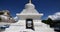 4k busy traffic & pedestrian through white stupa in Lhasa,Tibet.