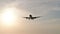 4K Camera follow silhouette aircraft landing at sunset or sunrise