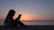 4K Child Playing Tablet on Beach, Sunset View Girl Silhouette Using Smart Phones